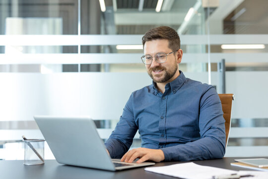 Remote work and digital transformation, professional man working on laptop in modern office with corporate productivity and business communication