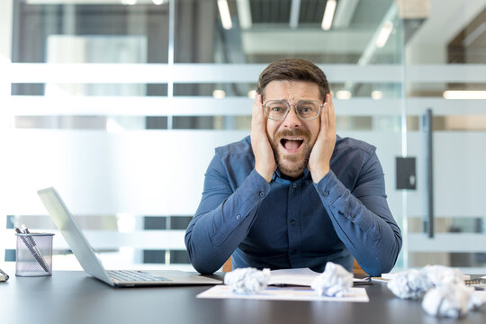 Workplace burnout and professional stress, overwhelmed businessman screaming with deadline pressure and anxiety in a modern corporate office