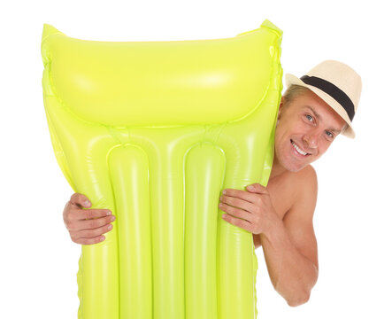 Happy man in swimsuit and hat with inflatable mattress on white background