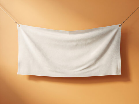 A minimalist white fabric banner mockup image hanging on a string against a warm beige background wall