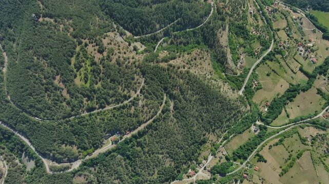 Aerial view of green hills and mountains and ethno village Mokra Gora, Serbia, 4k