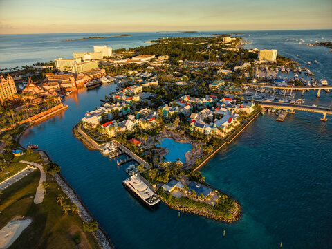 New Providence, The Bahamas - 03 January 2026: Aerial view of Paradise Island with luxury resorts, marina with yachts, and turquoise waters during the golden hour.