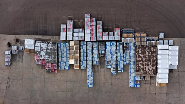 Englewood, Colorado, United States - 11 September 2026: Aerial view of industrial pallets and construction materials organized in rows on a concrete yard.