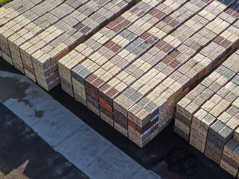 Scoresby, Australia - 09 September 2026: Aerial view of PGH Bricks Pavers Selection Centre featuring rows of neatly stacked bricks and pavers on pallets in an industrial yard.