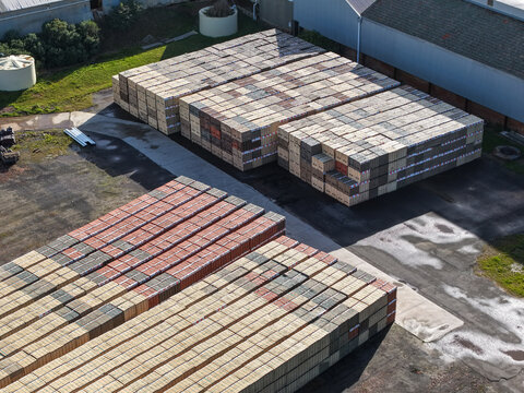 Scoresby, Australia - 09 September 2026: Aerial view of PGH Bricks Pavers Selection Centre with large stacks of bricks arranged in neat rows on the asphalt yard.