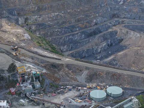 Montrose, Australia - 11 September 2026: Aerial view of the Boral Asphalt quarry showing deep excavation terraces, heavy machinery, and industrial processing facilities.