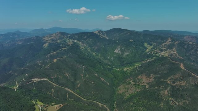 Aerial view of green hills and mountains and ethno village Mokra Gora, Serbia, 4k