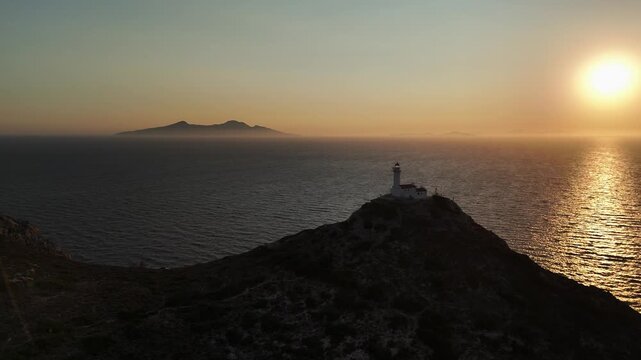 Dramatic Sunset Over Knidos Lighthouse and Foggy Sea Islands