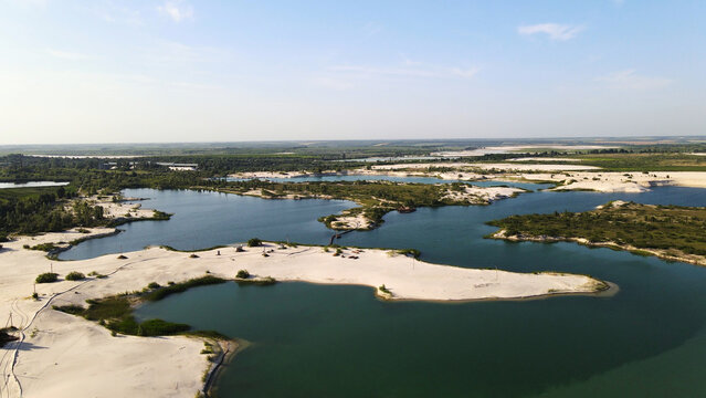 Sand quarry lakes with white sand beaches and lush green vegetation offering a unique aerial landscape view