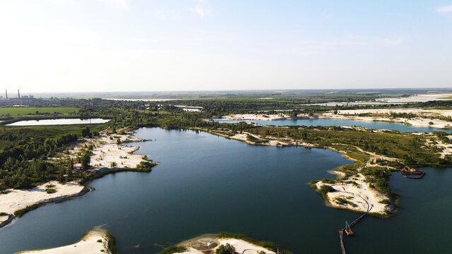 Landscape of a sand and gravel quarry operation with industrial equipment and facilities for extraction and processing visible