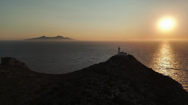 Dramatic Sunset Over Knidos Lighthouse and Foggy Sea Islands
