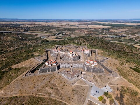 Elvas, Portugal - 10 September 2026: Aerial view of the star-shaped Forte de Nossa Senhora da Graca, a historic fortification on a hilltop surrounded by dry, rolling landscape.