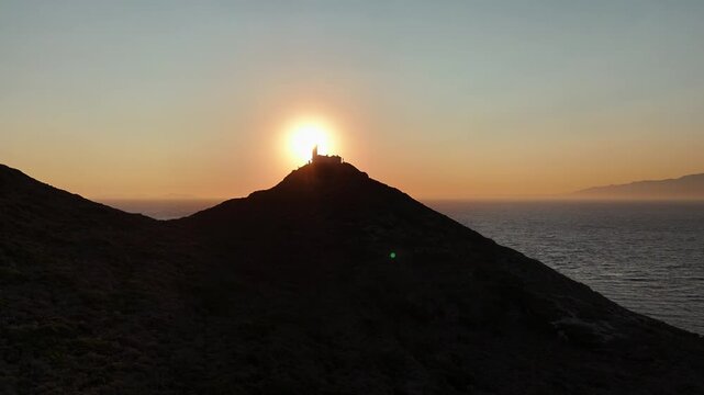 Dramatic Sunset Over Knidos Lighthouse and Foggy Sea Islands