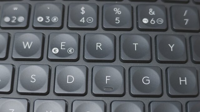 Qwerty keyboard close up on black keys