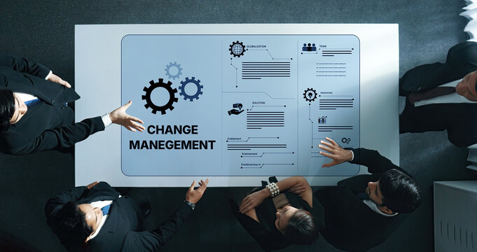 A dynamic business team collaborates on change management strategies around a table, featuring engaging visuals and gears, emphasizing innovation and effective planning. Trope