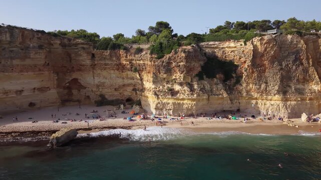 People sunbathing on marinha beach in algarve portugal