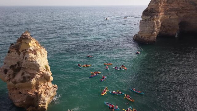 Tourists kayaking at marinha beach portugal