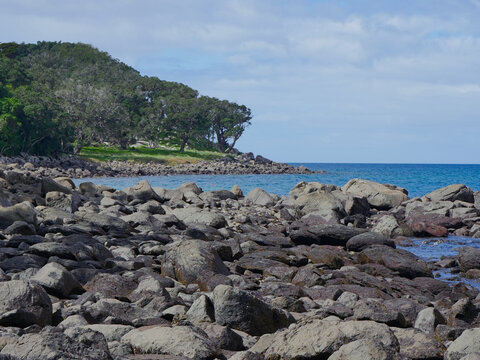 Scenic peninsula on the Matakana Coast with basalt boulders, native pohutukawa and puriri forests, nesting seabirds, and the Ti Point Coastal Walkway.