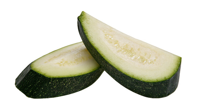 Isolated fresh raw zucchini slices cut lengthwise showing green skin and pale interior
