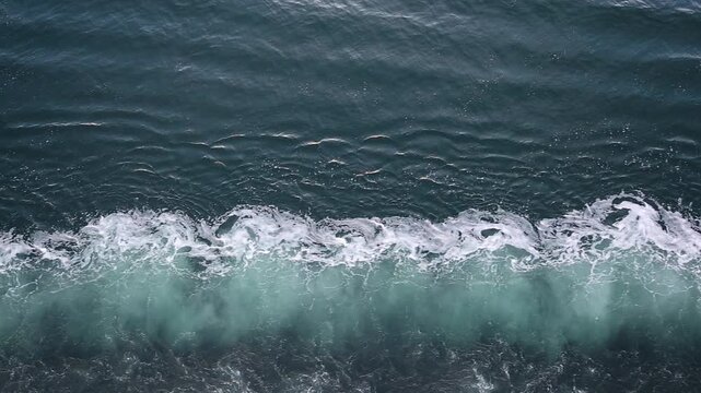 Slow motion top view of a ship's wake splashing water