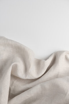 Linen fabric texture border isolated on white background natural eco folded linen background. Bio textile material backdrop, canvas top view, close up, vertical photo