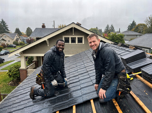 Roof repair, replacement with metal roofing tiles; two specialists are on the job.