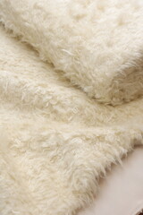 Luxurious soft white faux sheep fur fabric texture background, fluffy sherpa or teddy fleece textile material for winter fashion apparel and cozy home decor © Sceliano