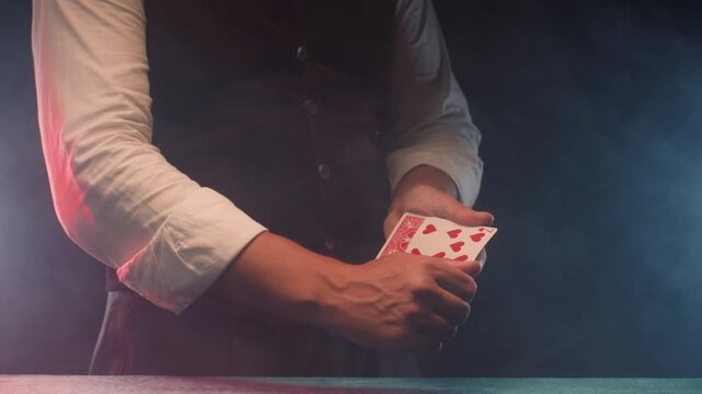 Magic trick, Professional croupier shuffling and dealing playing cards at a casino table, poker and blackjack game, magician performing a card trick shuffling cards deck