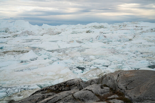 Iceberg in arctic landscape nature with icebergs and ice in Greenland icefjord. Photo of ice and iceberg. Ilulissat Icefjord with icebergs from glacier.
