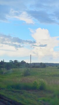 Scenic rural landscape with lush green fields and dramatic cloudy sky