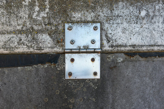 This metal hinge secures two concrete sections