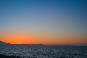 Fototapeta premium Golden Sunset Over the Sea and Mountains in Rethymno Crete
