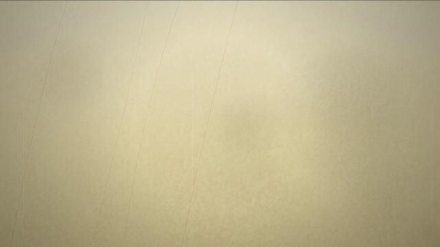 Abstract beige textured background with soft light leaks and subtle organic movement for overlays