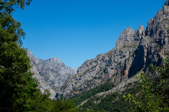 rugged peaks and iconic limestone peak of the Naranjo de Bulnes - also known as Picu Urriellu - in the Picos de Europa National Park in northern Spain