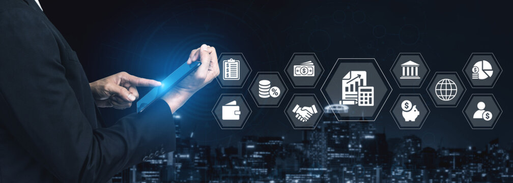 A business professional manages financial data using a tablet in an urban night environment, with futuristic icons symbolizing innovation and technology in finance and industry. Ledger