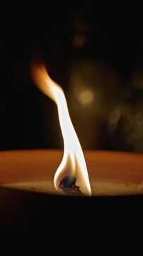 Close-up of a traditional candle burning on a grave in Poland during All Saints' Day.