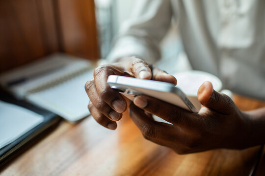 Business person using smartphone at cafe table