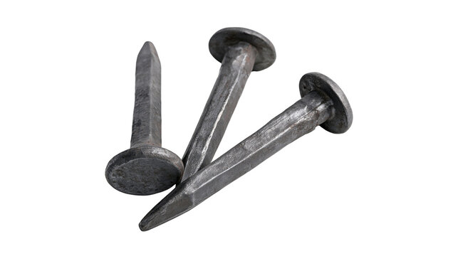Isolated group of three rustic vintage metal nails, dark old hand-forged carpentry tools