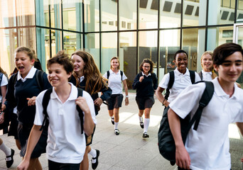 Fototapeta premium Group of students walking happily in school uniforms