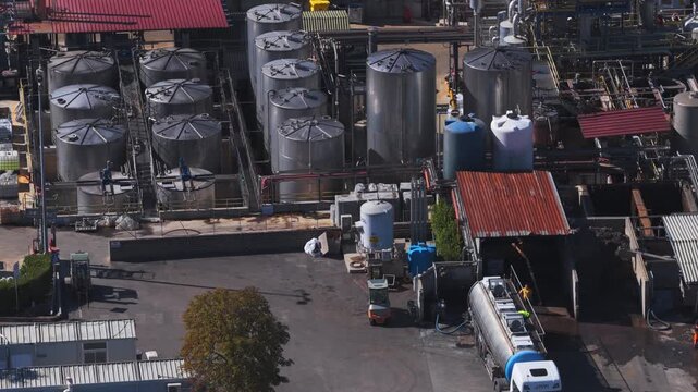 Aerial view of GSA Gruppo Servizi Ambientali industrial facility with storage tanks and trucks in Zona Pip, Lazio, Italy.