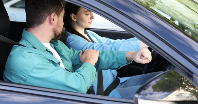 Woman having driving lesson with instructor in car