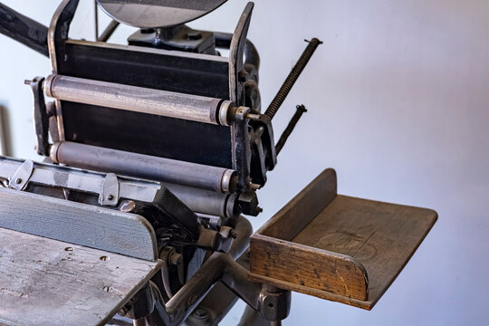 Close up of an antique letterpress printing machine. A nostalgic look at the mechanical beauty of antique letterpress technology. Highlights traditional manual printing technology.
