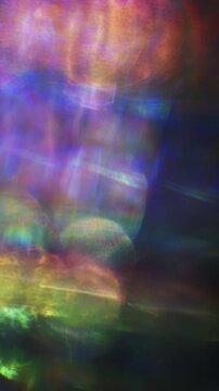 Dreamy bokeh of reflective shimmer with a dazzling shine and gleam of rainbow lens rays. Shining reflections creating visual of magical glittering lights and a glowing aura of iridescent colors. Loop