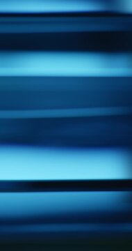 Radiant blue lights illuminate the brilliance of moving reflective glass creating a gradient of soft blues for a calm, relaxing aura. Smooth dreamy blue lighting abstract background or wallpaper Loop