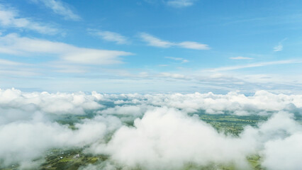 Fototapeta premium Above, vast clouds drift beneath clear blue sky