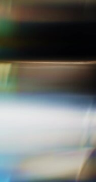 Colorful light refraction of smooth reflective glass prism with lens chromatic aberration and optical distortion effects in a rainbow of colors. Shining lights reflect highlights on angled glass Loop