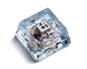 Fototapeta premium Transparent mechanical key switch over a reflective surface, close-up