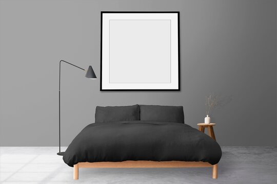 Minimal modern bedroom with black bed and framed wall art