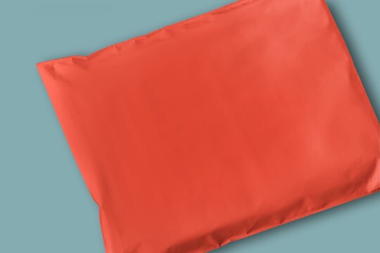 Red pillow on blue background, minimal product mockup