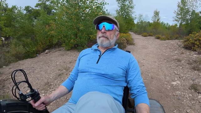 Senior cyclist is riding a full suspension recumbent tricycle on a rough gravel trail in northern Colorado - late summer scenery with rabbitbrush in North Shields Ponds Natural Area